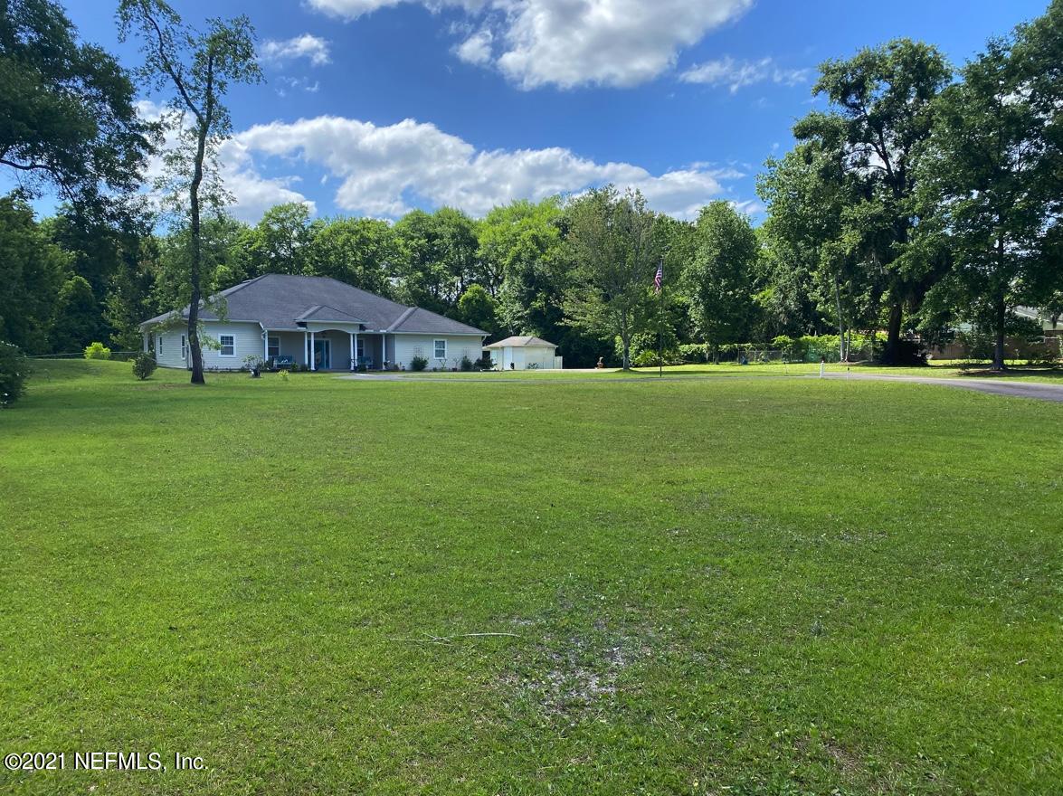 1386 Long Bay Road Middleburg, FL 32068 - Photo 38 of 40 a front view of a house with a garden
