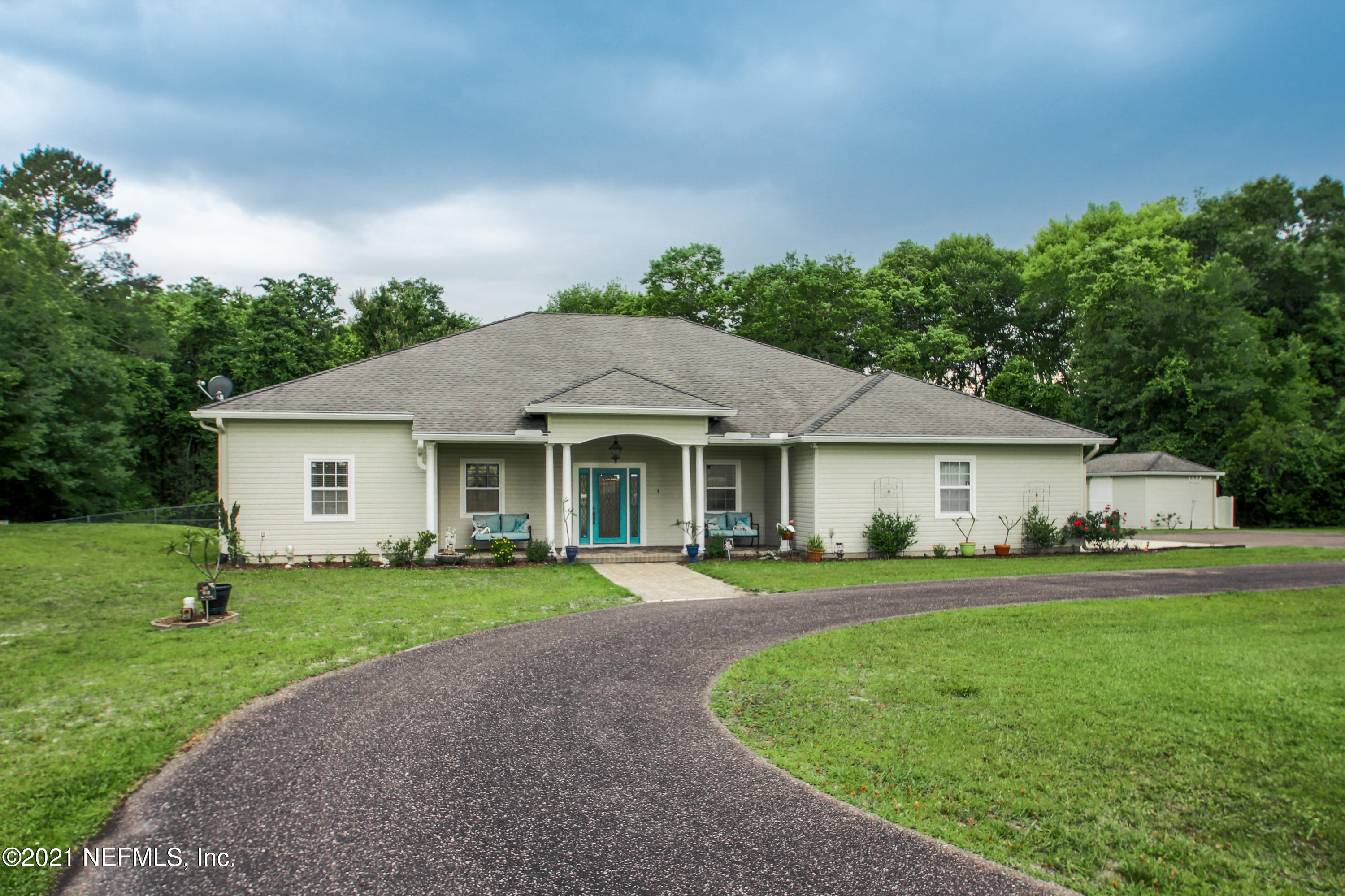 1386 Long Bay Road Middleburg, FL 32068 - Photo 4 of 40 a front view of a house with a yard and trees