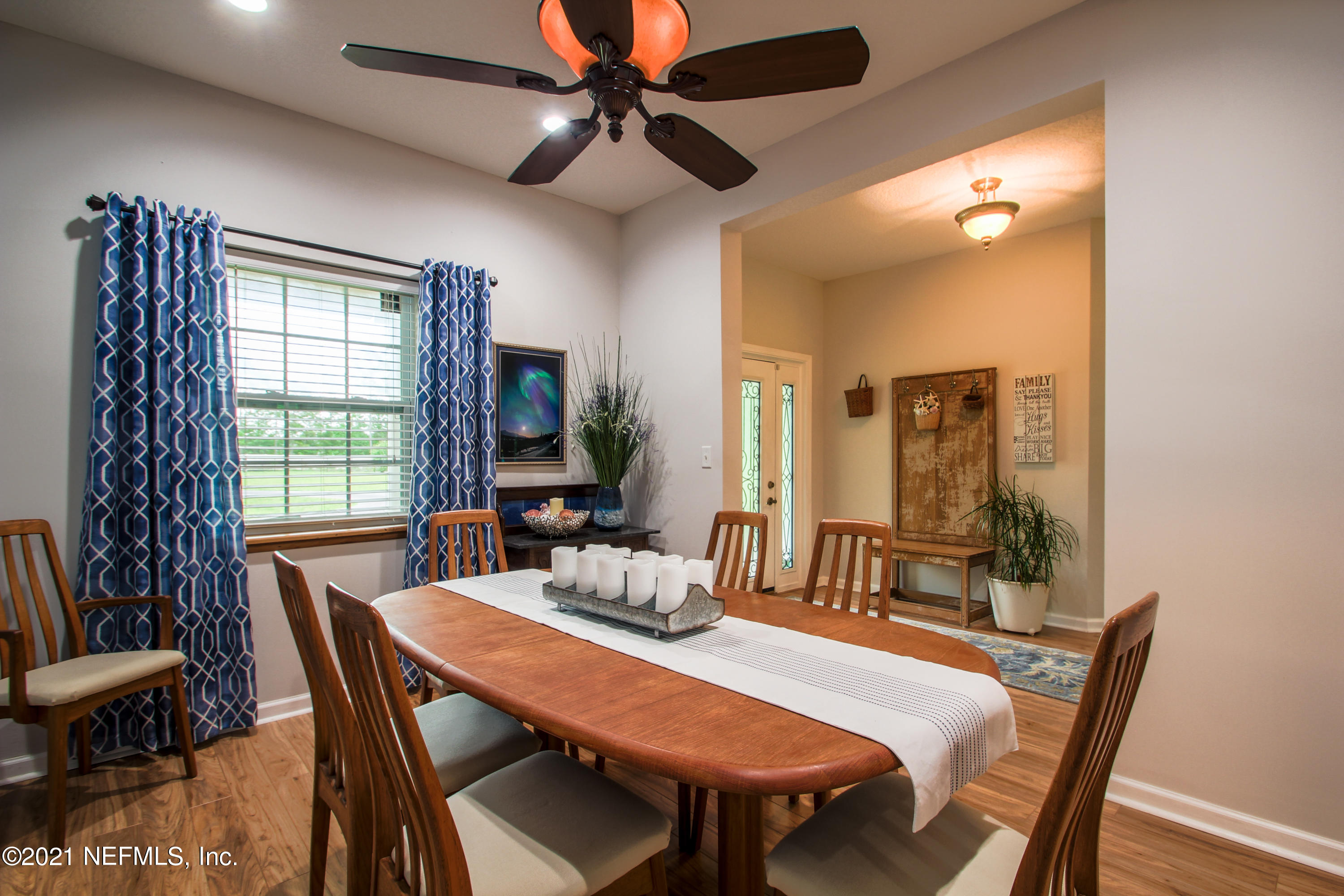 1386 Long Bay Road Middleburg, FL 32068 - Photo 8 of 40 a view of a dining room with furniture window and wooden floor
