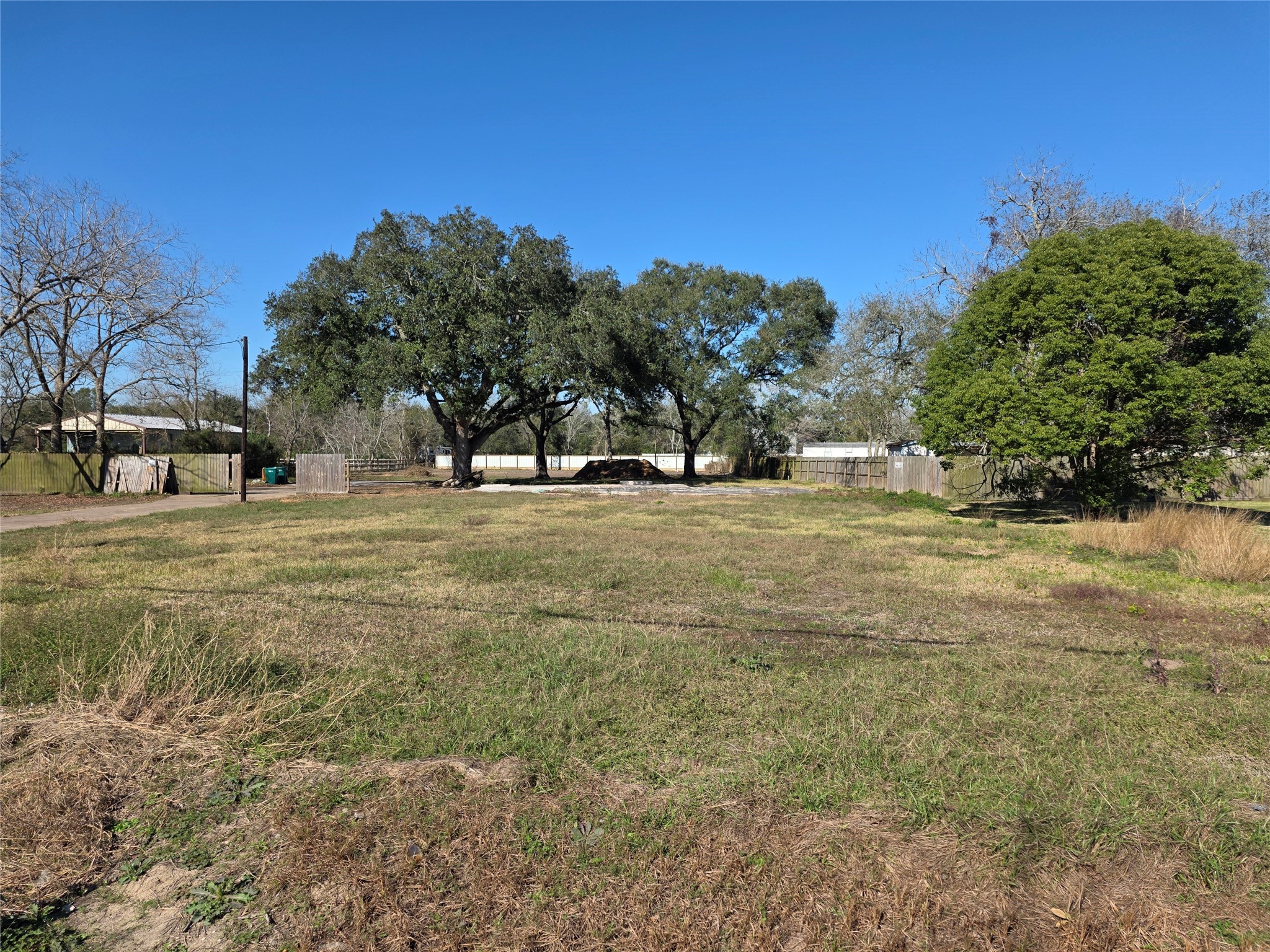 a view of a field with trees in the background