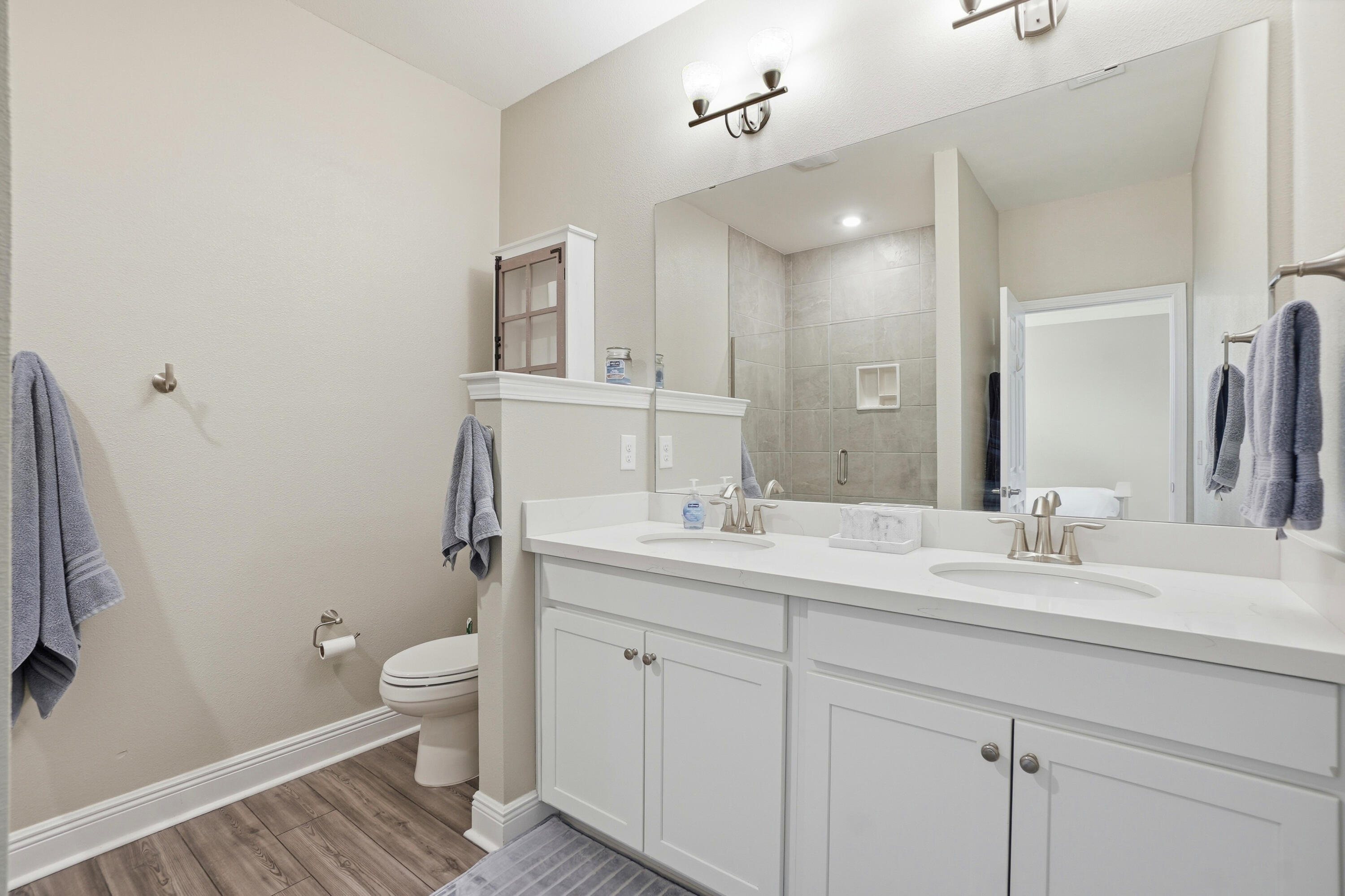525 Windchime Way Freeport, FL 32439 - Photo 21 of 59 a bathroom with a toilet sink double vanity and mirror