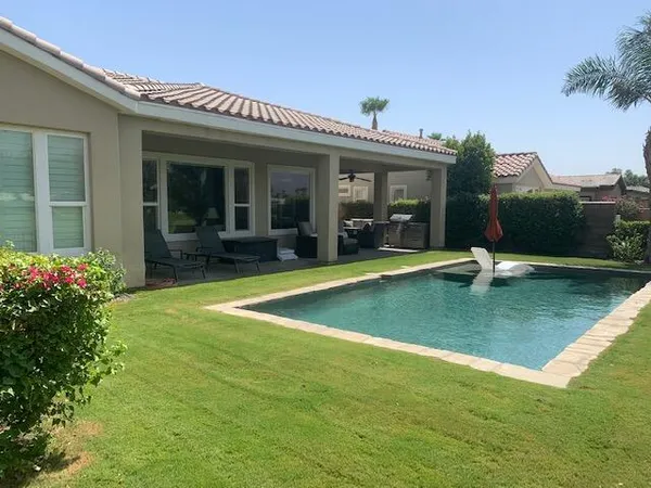 a view of a house with pool and porch