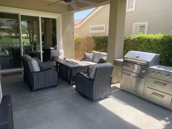 a living room with furniture and a floor to ceiling window