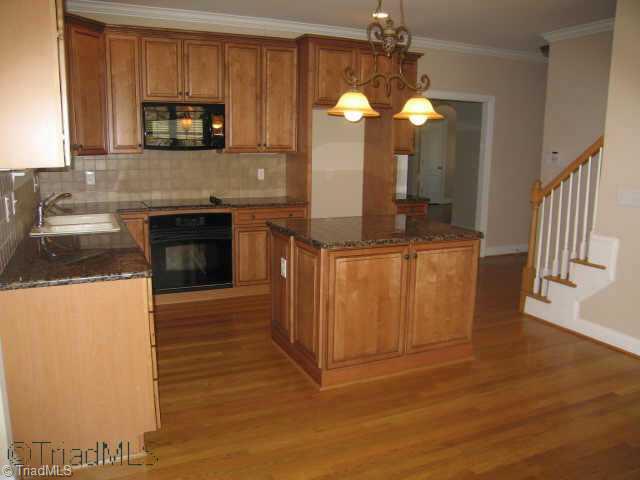 4908 Robdot Drive Oak Ridge, NC 27310 - Photo 3 of 9 Other. Kitchen with granite countertops and kitchen bar.