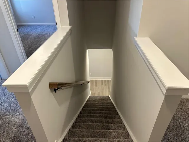 an empty room with wooden floor and white walls