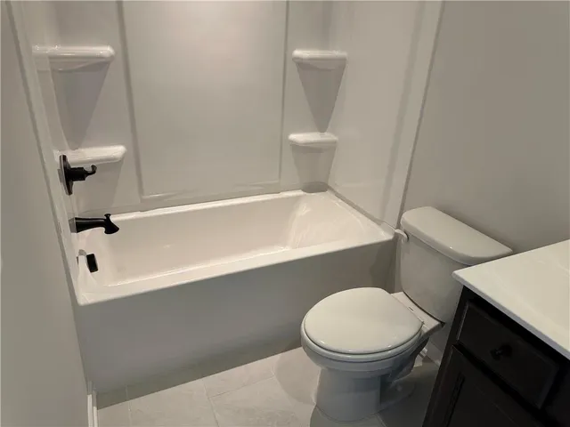 a front view of a building with a yard