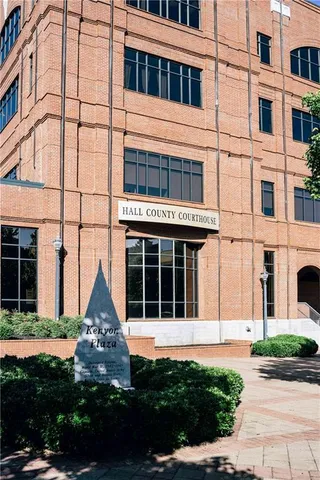 a front view of a building and car parked