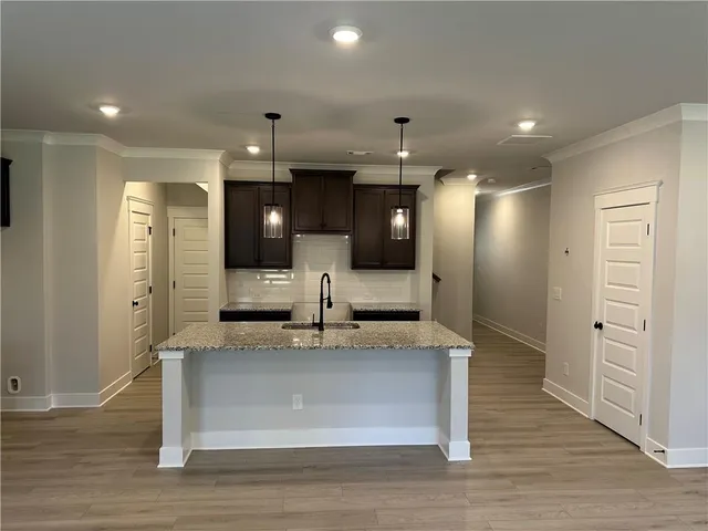 a view of large kitchen with a sink and a refrigerator