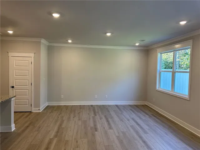 a view of hallway with wooden floor and stairs