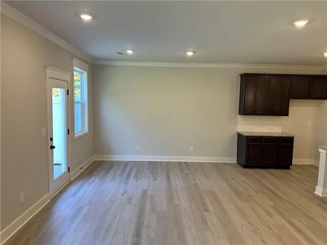 a kitchen with kitchen island granite countertop a sink a counter top space appliances and cabinets