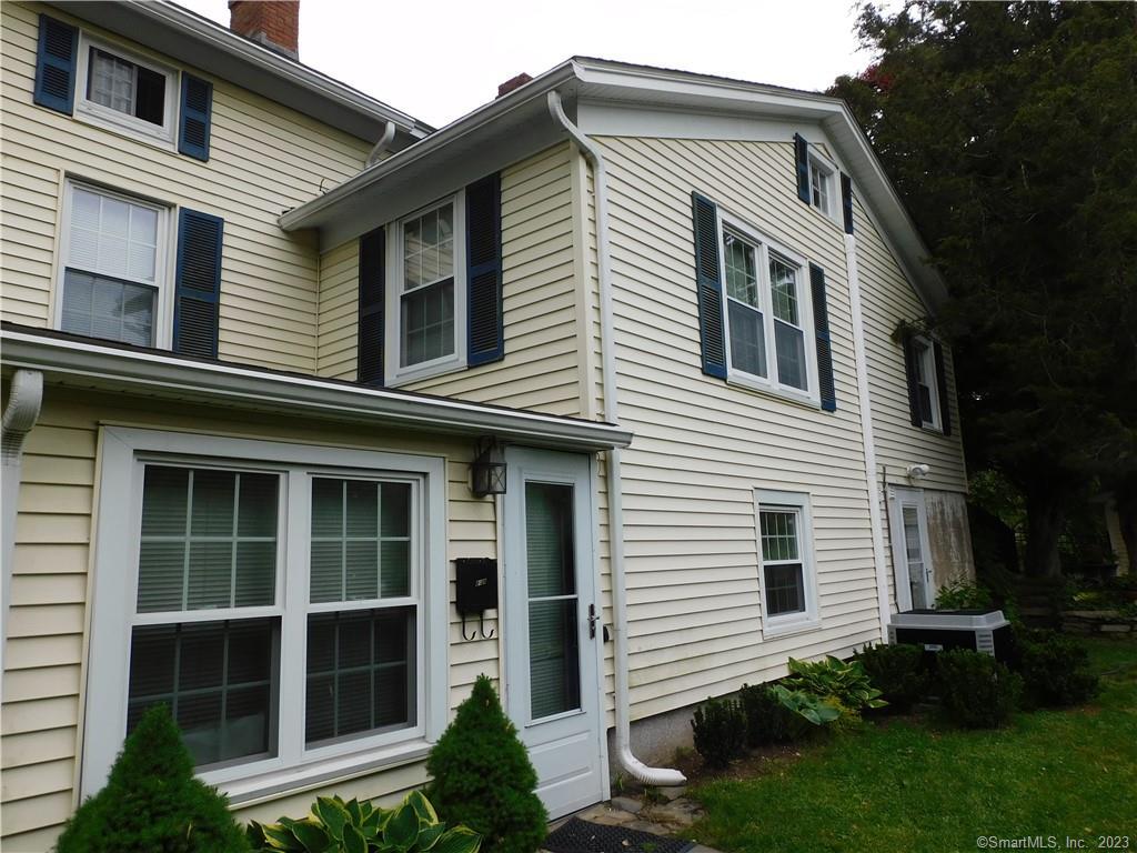 402 Boston Street Guilford, CT 06437 - Photo 4 of 40 Side of house along driveway with side entrance to ground level living area
