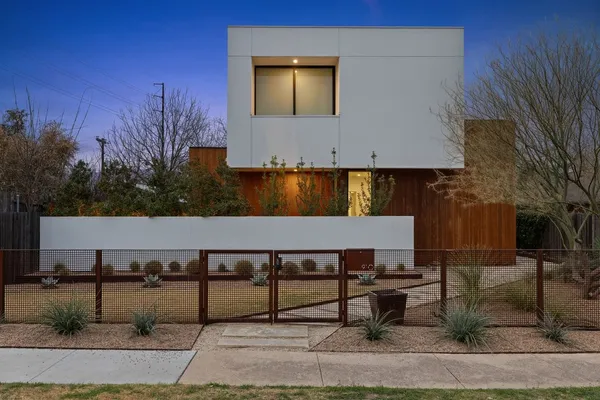 a large living room with stainless steel appliances granite countertop couches a fireplace with wooden floor