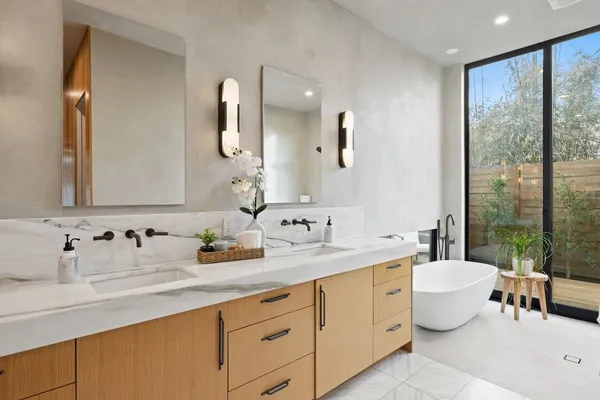 a bathroom with a double vanity sink and a mirror