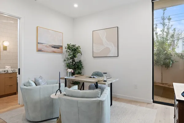 a living room with a flat screen tv and outdoor space