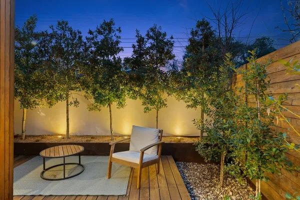 a view of patio with table and chairs and potted plants