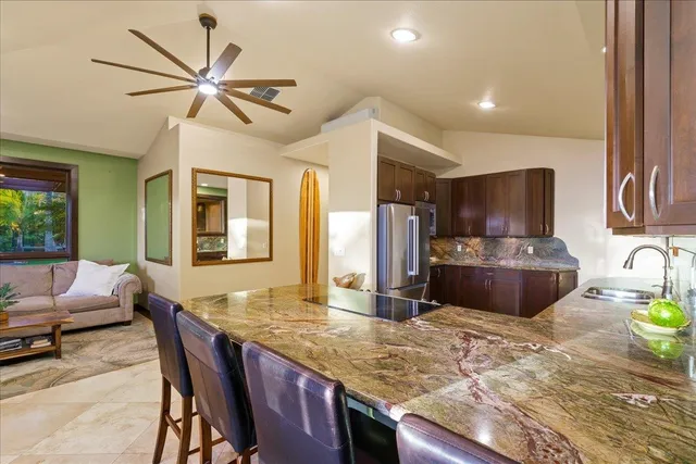 a kitchen with a stove a sink a dining table and chairs