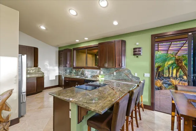 a kitchen with sink and refrigerator
