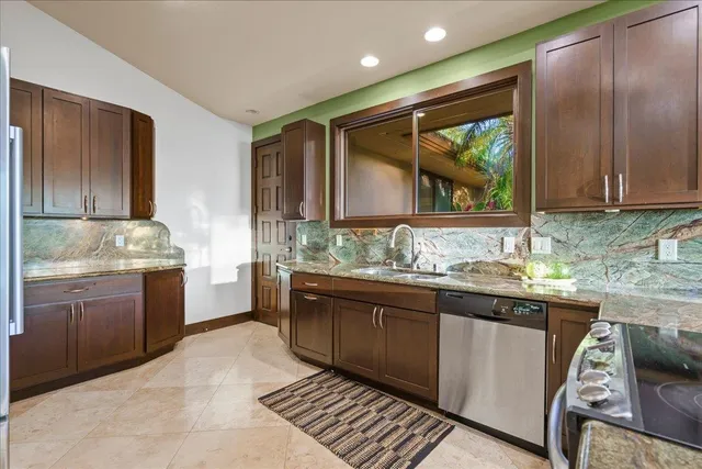 a kitchen with a sink stove and cabinets