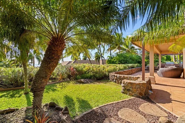 a view of backyard with swimming pool and seating