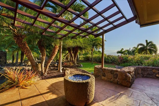 a backyard of a house with barbeque oven table and chairs