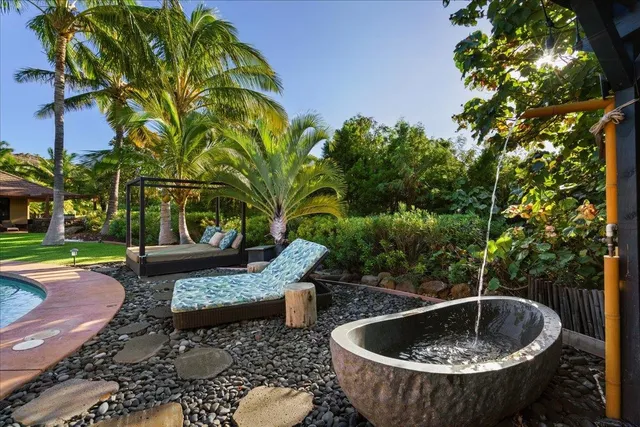 a view of a backyard with sitting area and tub