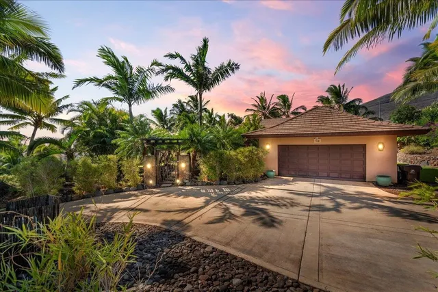 a big house with palm trees in front of it