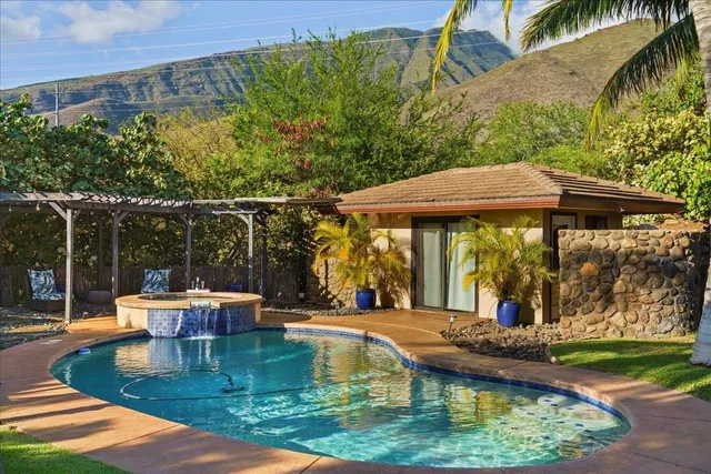 swimming pool view with a seating space