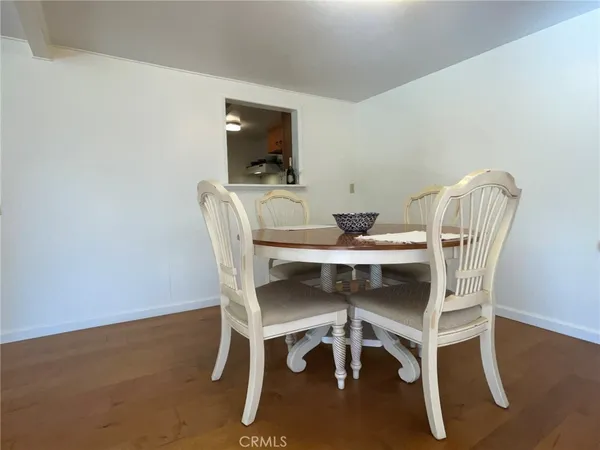a dining room with furniture and wooden floor