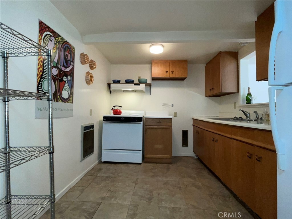 21455 Delta Way, Unit 2 Monte Rio, CA 95462 - Photo 19 of 48 a kitchen with stainless steel appliances a refrigerator sink and cabinets