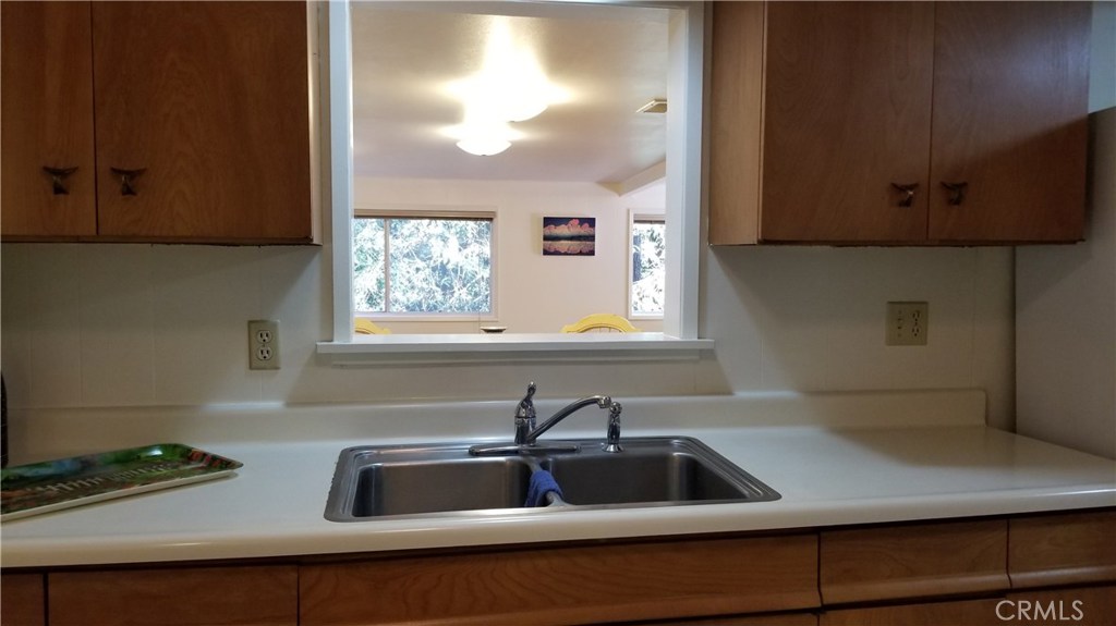 21455 Delta Way, Unit 2 Monte Rio, CA 95462 - Photo 24 of 48 a kitchen with white cabinets and a sink
