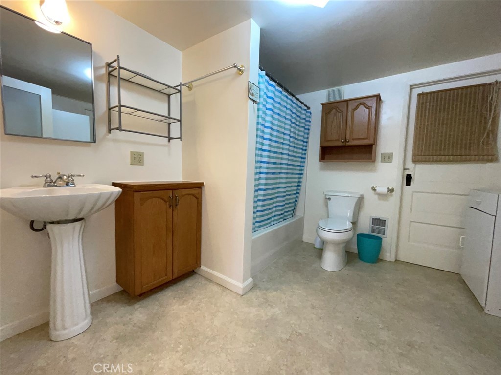 21455 Delta Way, Unit 2 Monte Rio, CA 95462 - Photo 35 of 48 a bathroom with a sink toilet and mirror
