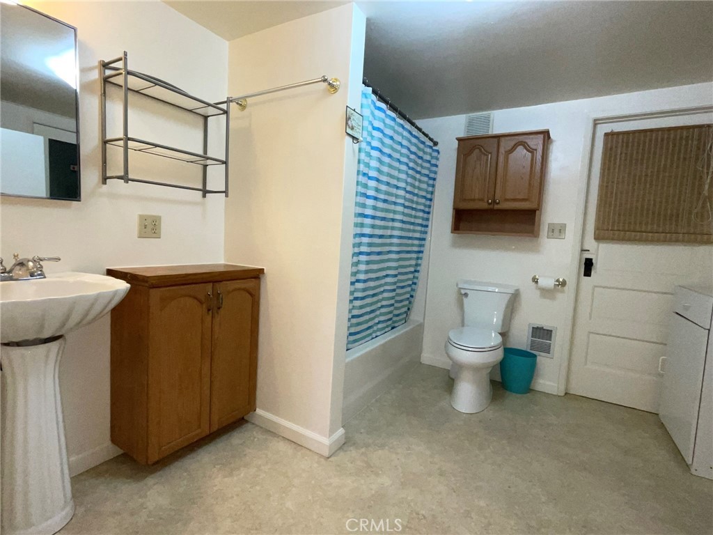 21455 Delta Way, Unit 2 Monte Rio, CA 95462 - Photo 37 of 48 a bathroom with a sink a toilet and mirror