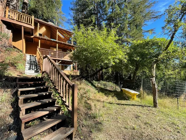 a view of balcony with wooden floor and fence