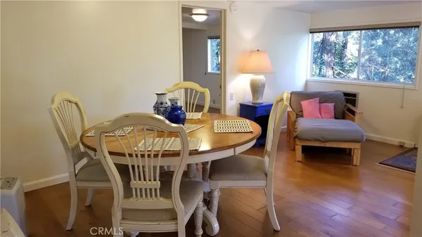 a living room with furniture a window and a chandelier
