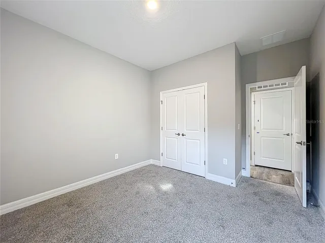 a view of an empty room and closet area