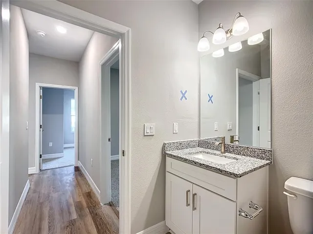 a kitchen with a refrigerator stove and white cabinets