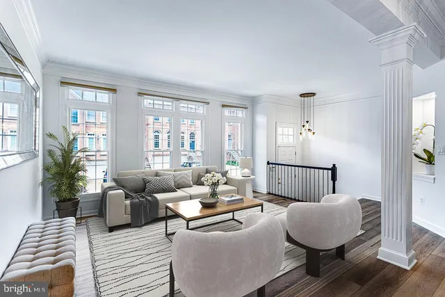a living room with furniture a chandelier and a fireplace