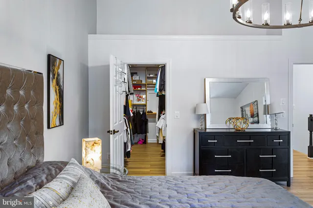 a living room with furniture windows and kitchen view