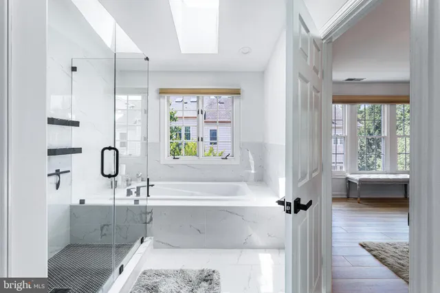 a living room with stainless steel appliances kitchen island granite countertop furniture and a wooden floor