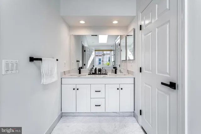 a kitchen with stainless steel appliances a stove a sink and a refrigerator
