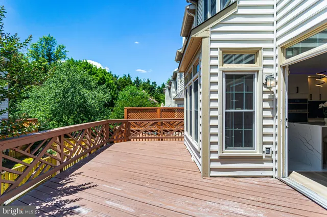 a view of a backyard with wooden floor and fence