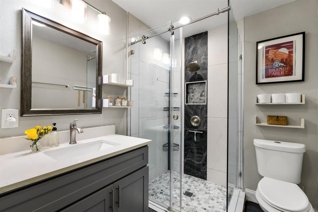 3236 Merrell Road Dallas, TX 75229 - Photo 14 of 24 a bathroom with a sink a toilet and shower