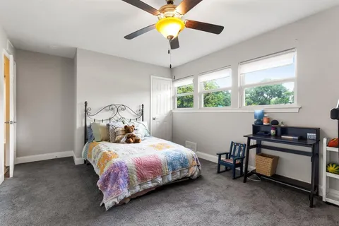 a bedroom with a bed and a chandelier