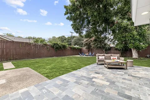 a view of a park with furniture and garden