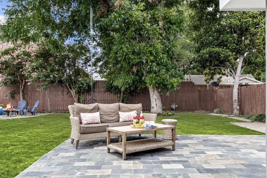 3236 Merrell Road Dallas, TX 75229 - Photo 19 of 24 a backyard of a house with fountain table and chairs