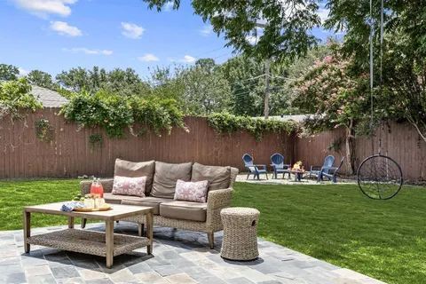 a view of a table and chairs in the back yard