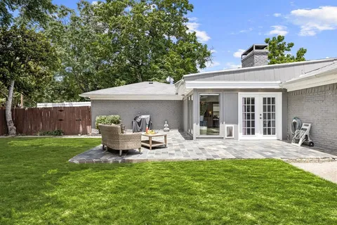 a front view of a house with garden and porch