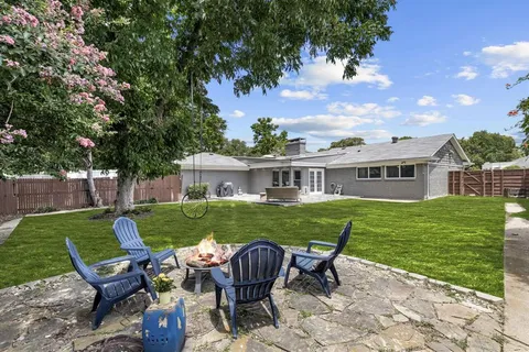 a view of a house with backyard porch and sitting area