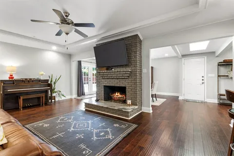 a living room with furniture fireplace and flat screen tv