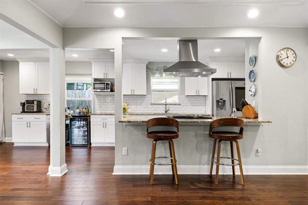 3236 Merrell Road Dallas, TX 75229 - Photo 9 of 24 a kitchen with counter top space cabinets and stainless steel appliances